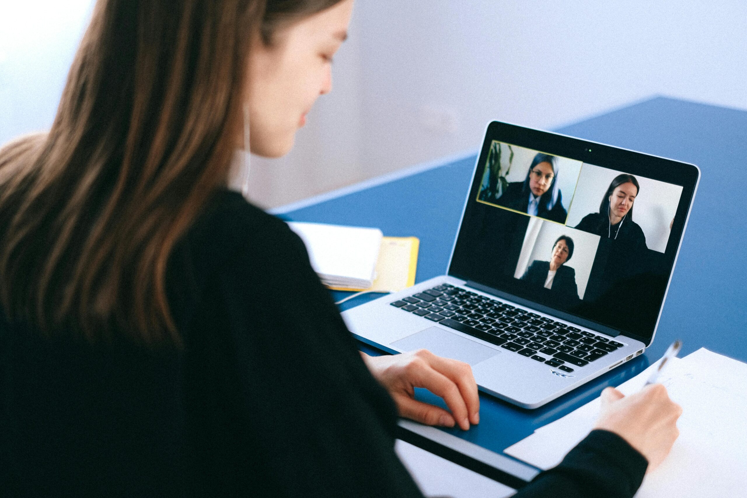Smiling wellness professional working efficiently at laptop after automating client workflow